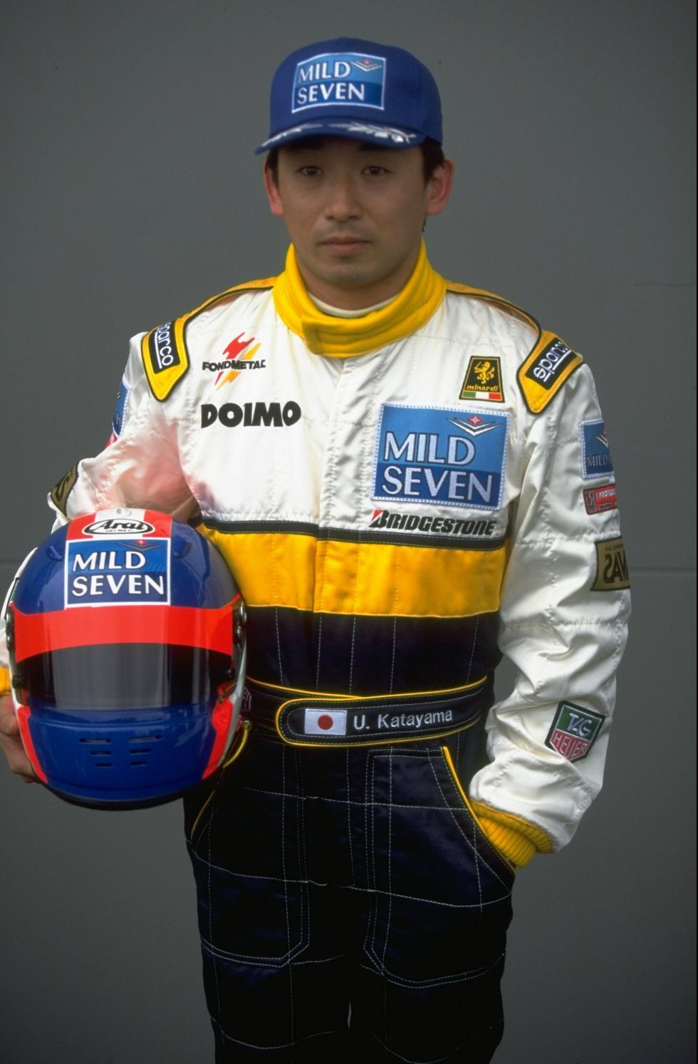 a man wearing a race car uniform