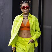 milan, italy   february 27 karina nigay poses ahead of the msgm fashion show wearing a lime green denim jacket with matching jeans, orange crop top and yellow mini bag, during the milan fashion week fallwinter 20222023 on february 27, 2022 in milan, italy photo by claudio laveniagetty images
