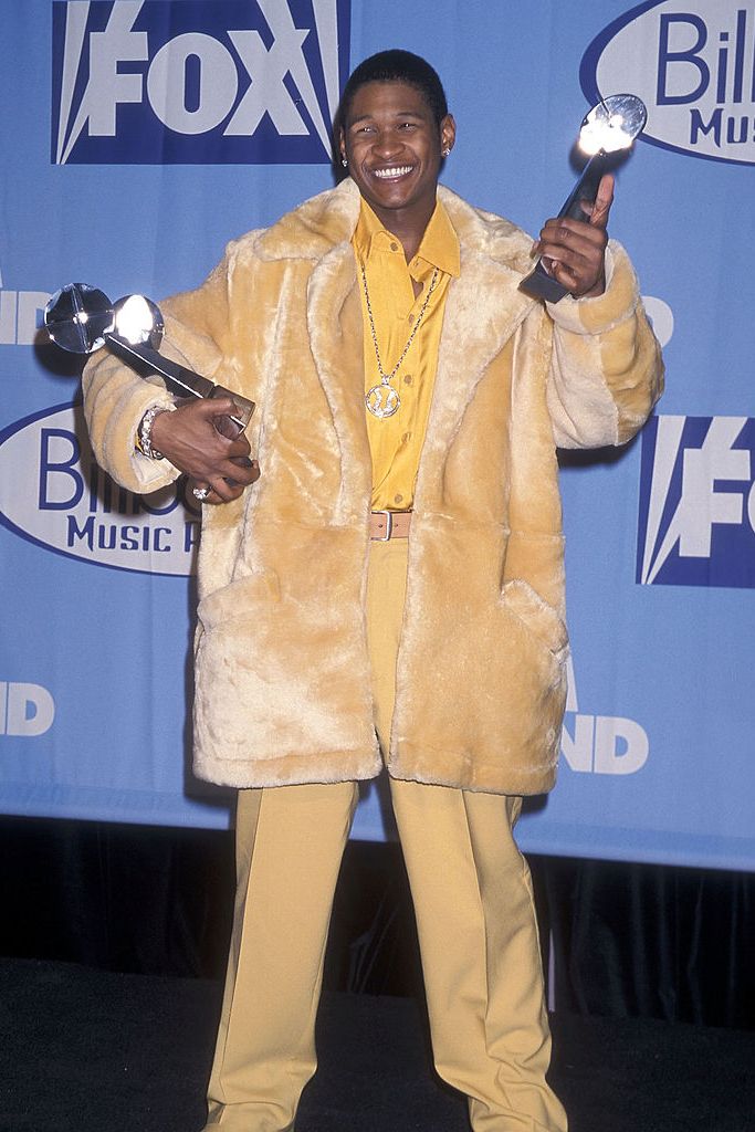 best 90s fashion trends, man, usher, wearing a yellow fur coat during awards ceremony
