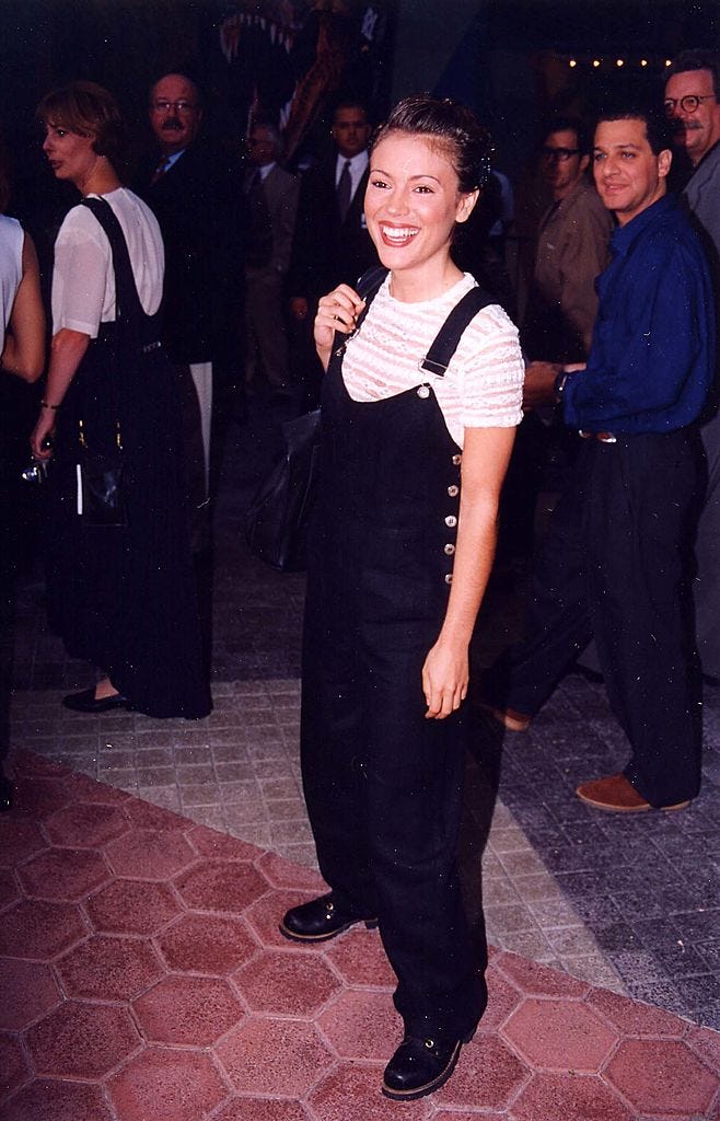 best 90s fashion trends, woman wearing black overalls