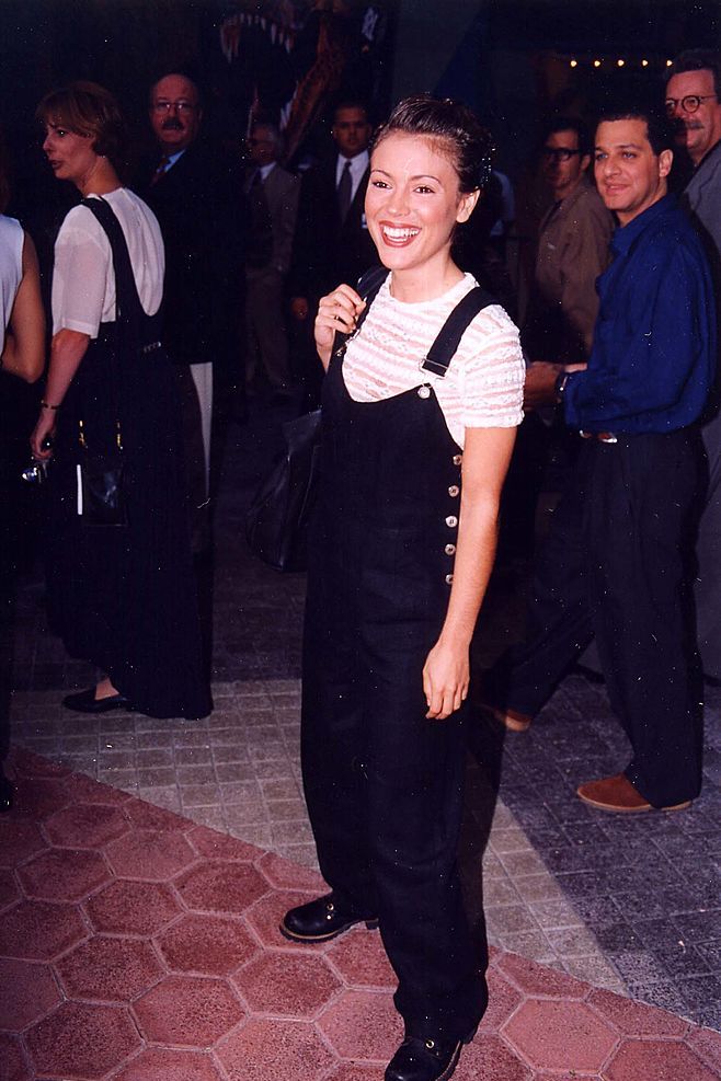 best 90s fashion trends, woman wearing black overalls