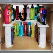viral tiktok under sink white shelf holding a selection of items