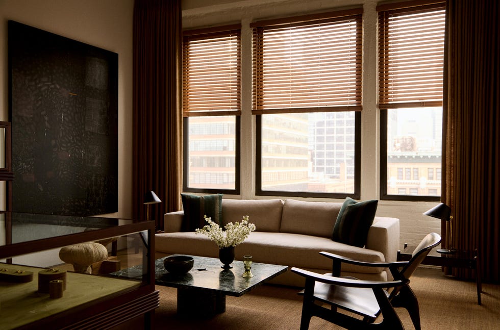 Modern living room with large windows and stylish furniture.