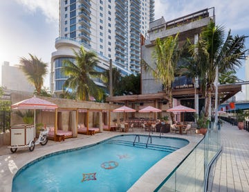 a miami beach club pool with a louis vuitton makeover