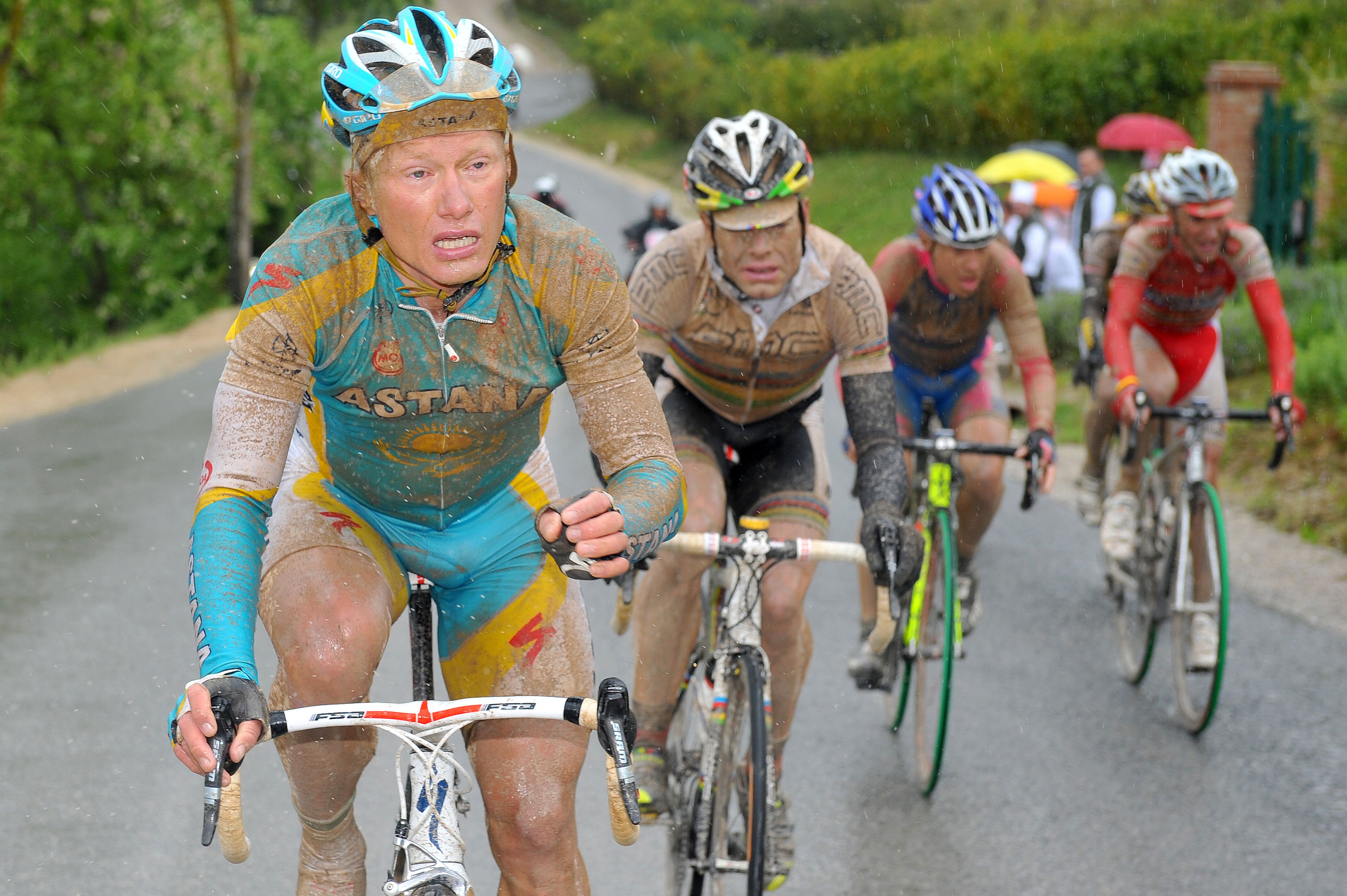 Alexandre Vinokourov and Cadel Evans push through the mud during Stage 7 of the 2010 Giro.