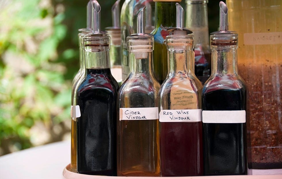 a selection of homemade vinegar on a table 