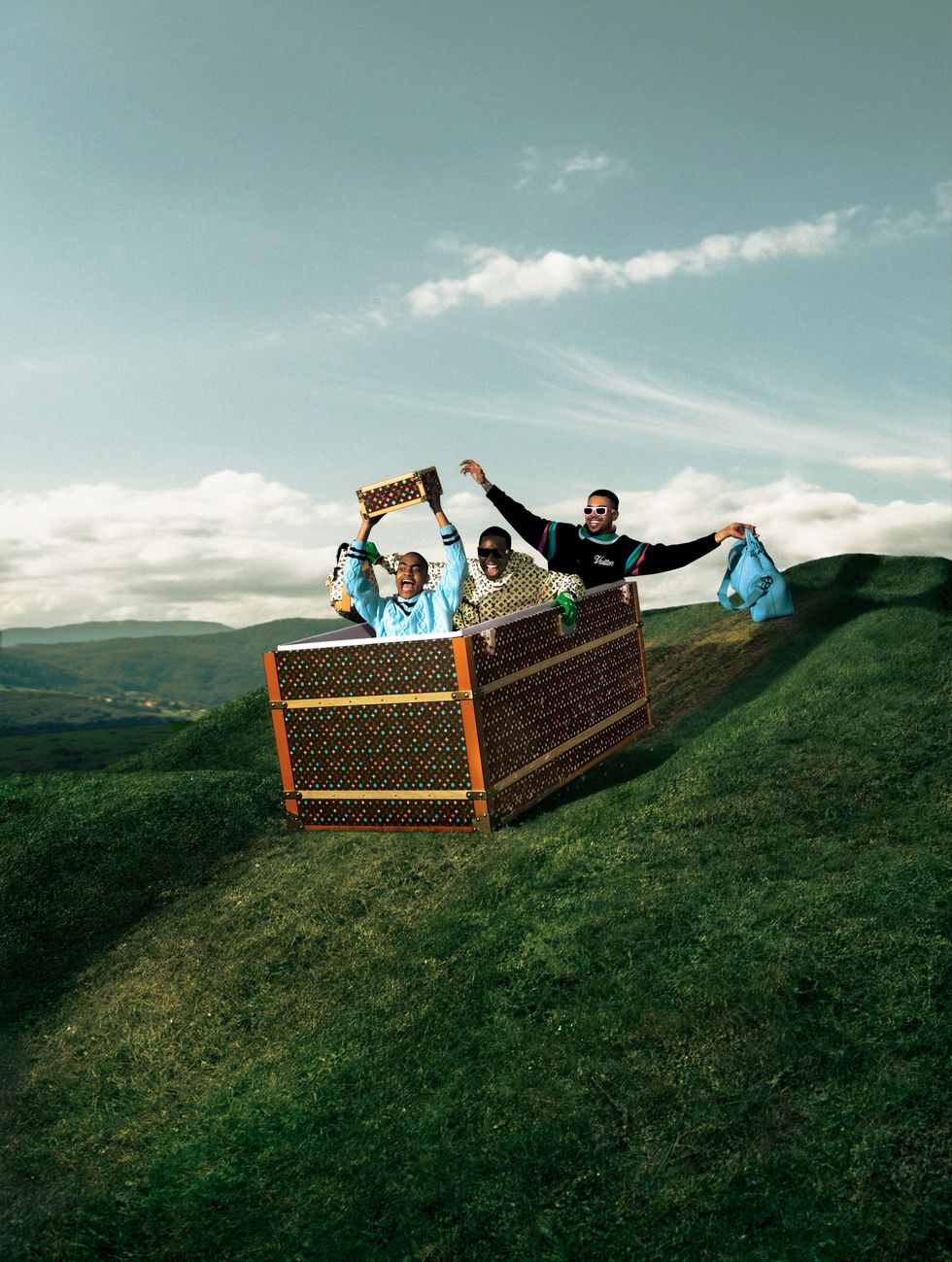 a group of people in a basket on a grassy hill