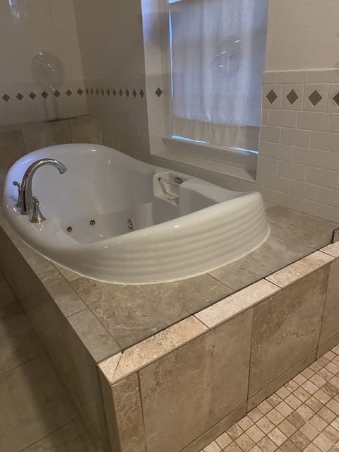 tiled bathroom and white tub