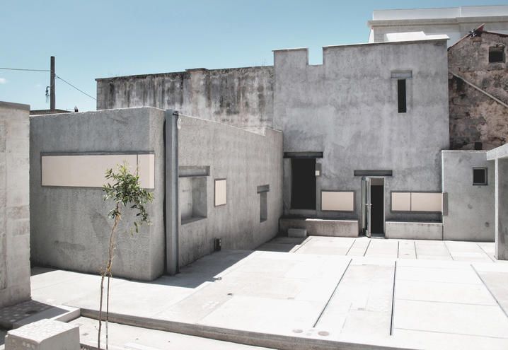Property, Wall, Concrete, Composite material, Door, Cement, Building material, Urban design, Shadow, Courtyard, 
