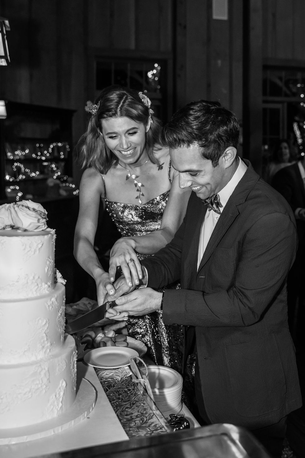 a bride and groom cutting a wedding cake