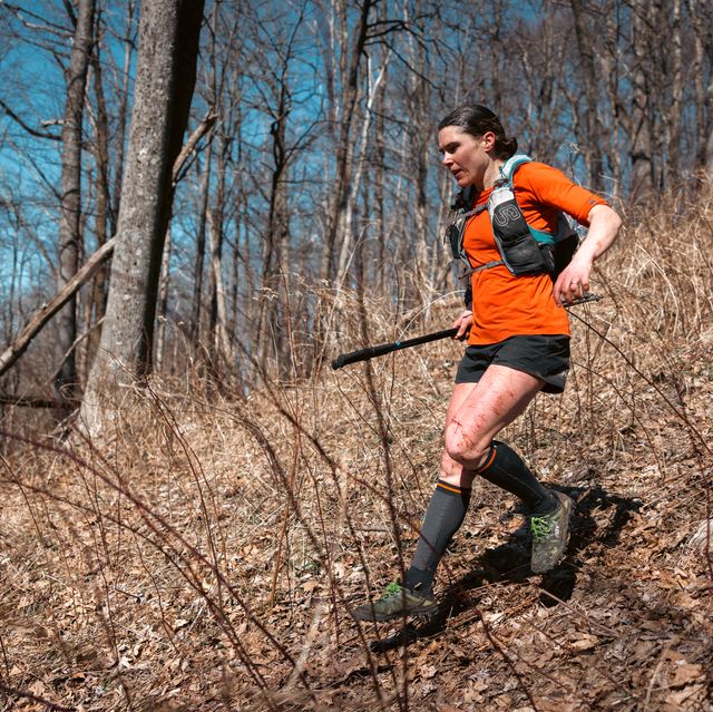 a woman running on a trail