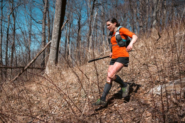 a woman running on a trail