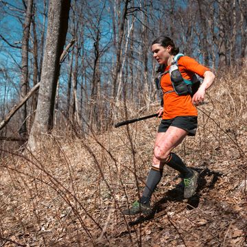 a woman block running on a trail