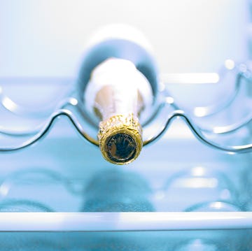 A bottle of champagne in a fridge