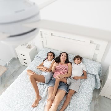 a family uses the remote to activate the electric ceiling fan, view from above