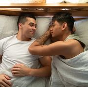 a gay couple sleep in their bed