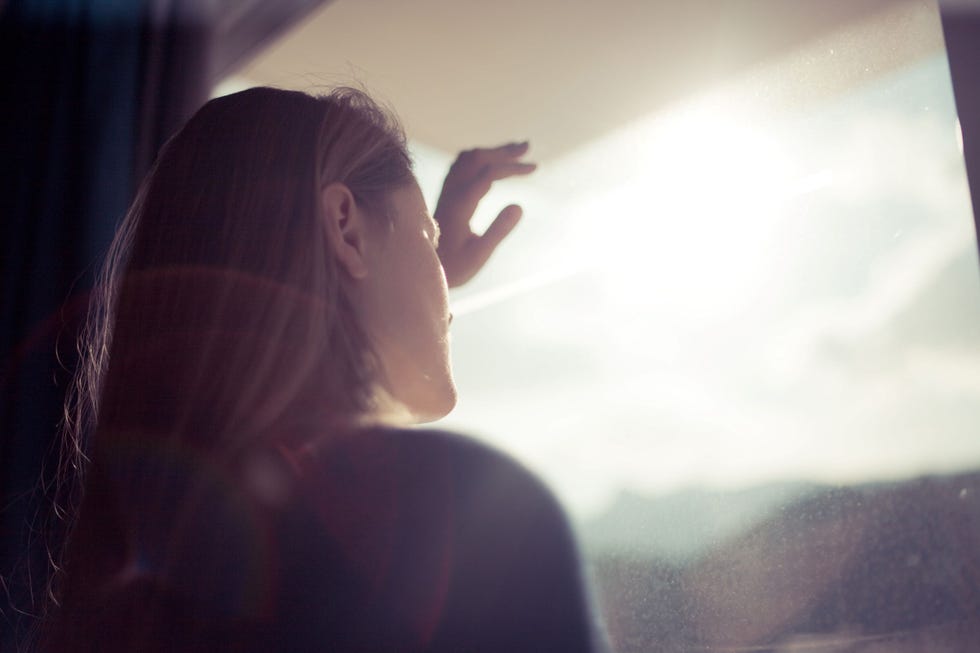 a person looking out a window