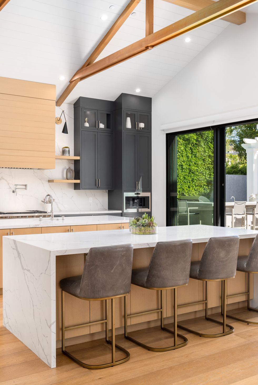 a large open kitchen with black and white countertops and white island