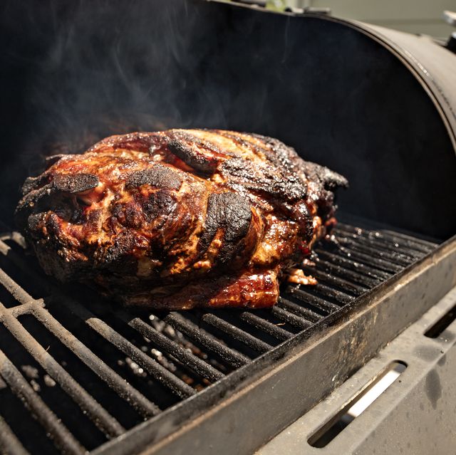 https://hips.hearstapps.com/hmg-prod/images/a-large-pork-butt-sitting-on-a-grill-plate-being-royalty-free-image-1625663159.jpg?crop=0.668xw:1.00xh;0.105xw,0&resize=640:*