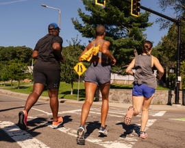 group of runners crossing a street