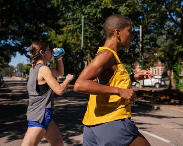 two women jogging on a sunny street