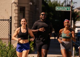 three runners smiling