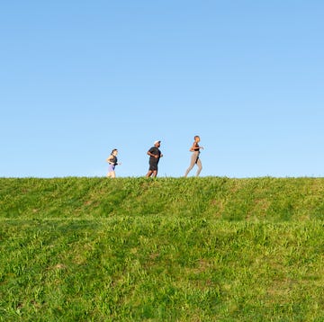 RWX three people running along a ridge with a blue sky