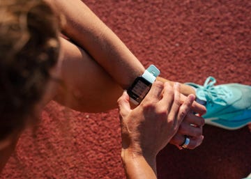 woman checking smartwatch after running