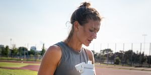 dehydration symptoms runner holds a water bottle after a track workout