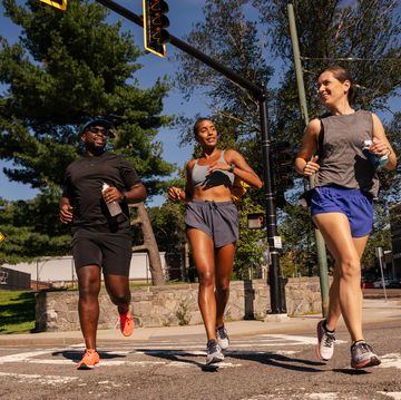 group of runners crossing a crosswalk in boston