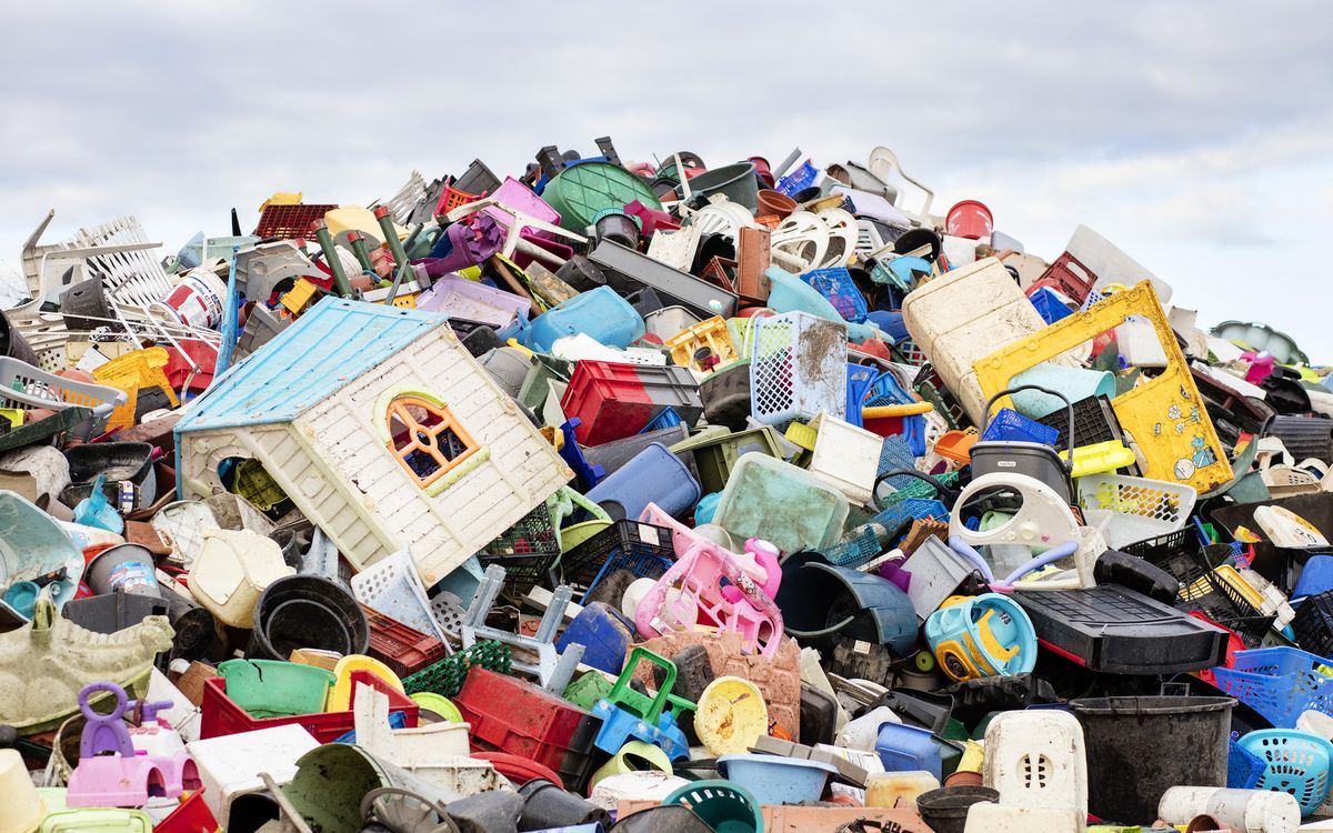 a mountain of plastic goods at a recycling plant