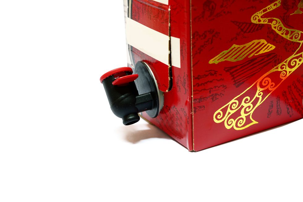 a paper box of red wine with black cock on white background isolated