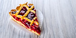 a piece of cherry pie on a wooden surface