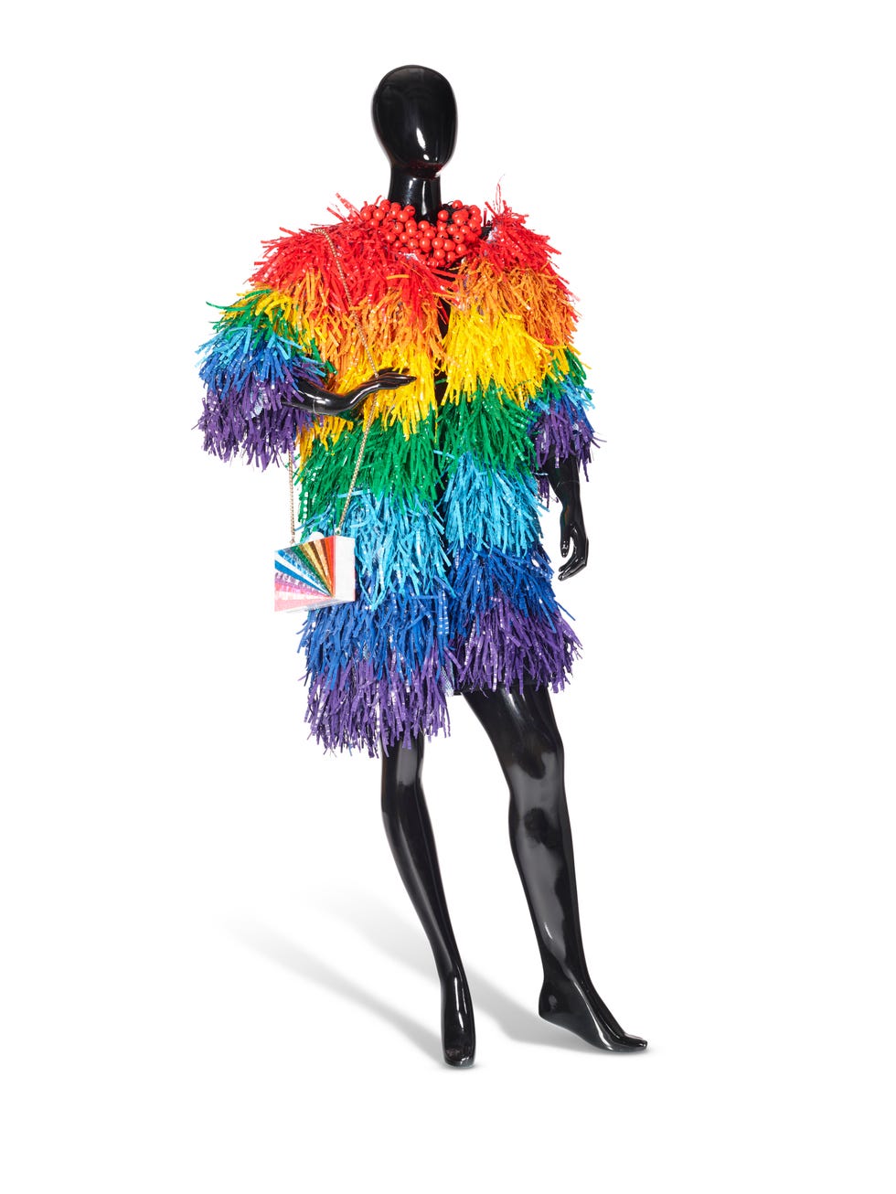 colorful fringe dress on a mannequin with a beaded necklace and rainbow handbag