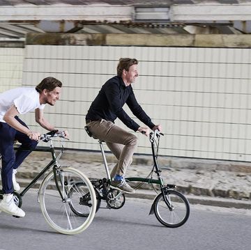 two men riding bicycles