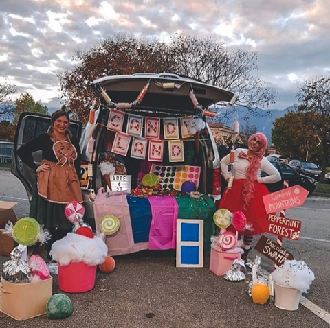 a car decked out for trunk or treat in a candyland theme with colorful candies and game pieces