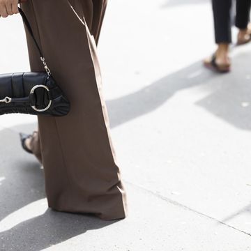 a person carrying a gucci horsebit handbag