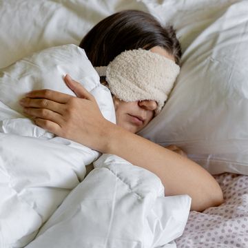 vrouw met oogmasker op in bed