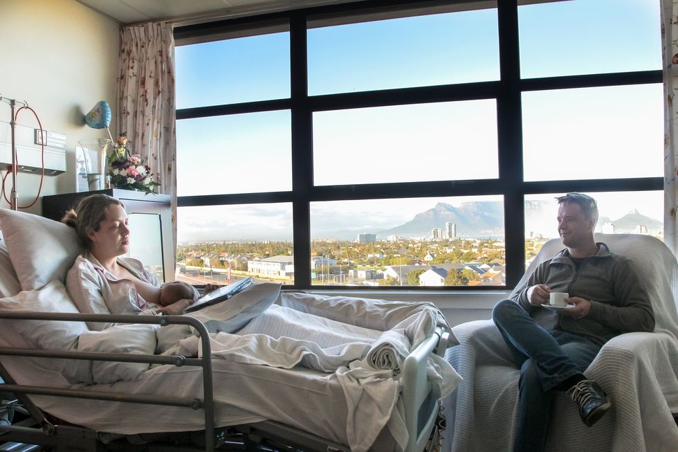 a young man spends time with his wife in hospital as she recovers from a caesarean section