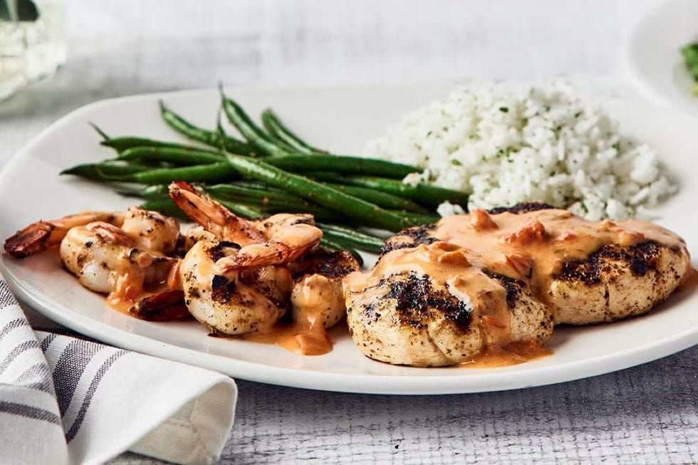 serving of grilled shrimp and chicken with vegetables and rice