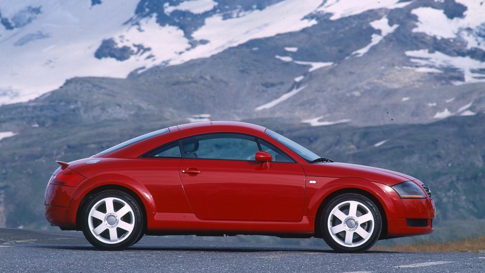 audi tt in red with mountains behind it