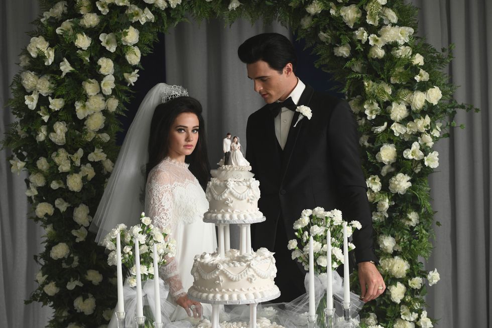 a bride and groom cutting a wedding cake