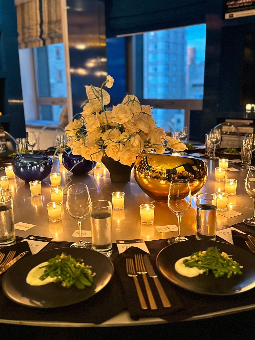 Elegant dining table set with food, decorative elements, and candles