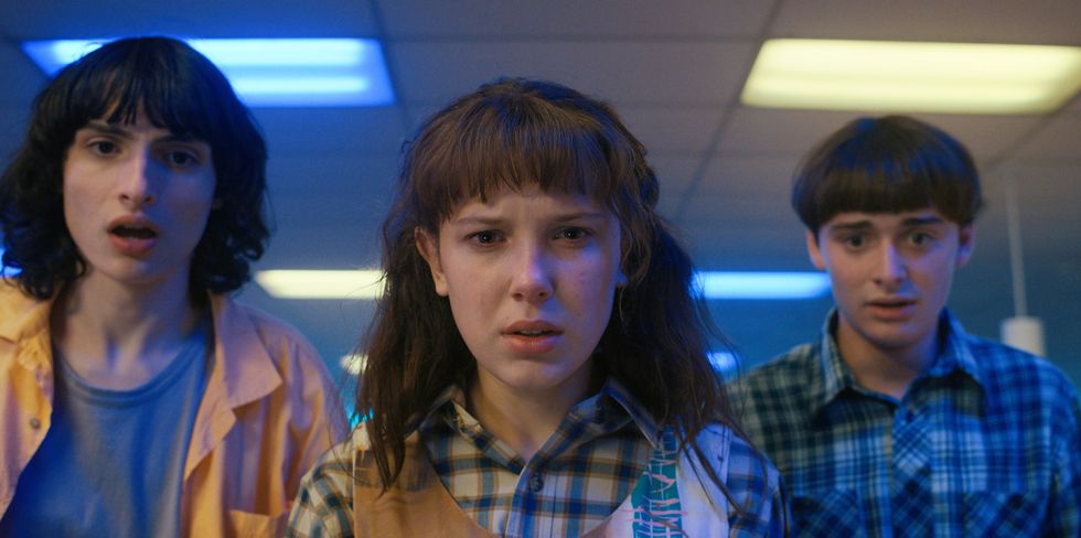 stranger things l to r finn wolfhard as mike wheeler, millie bobby brown as eleven and noah schnapp as will byers in stranger things cr courtesy of netflix  © 2022