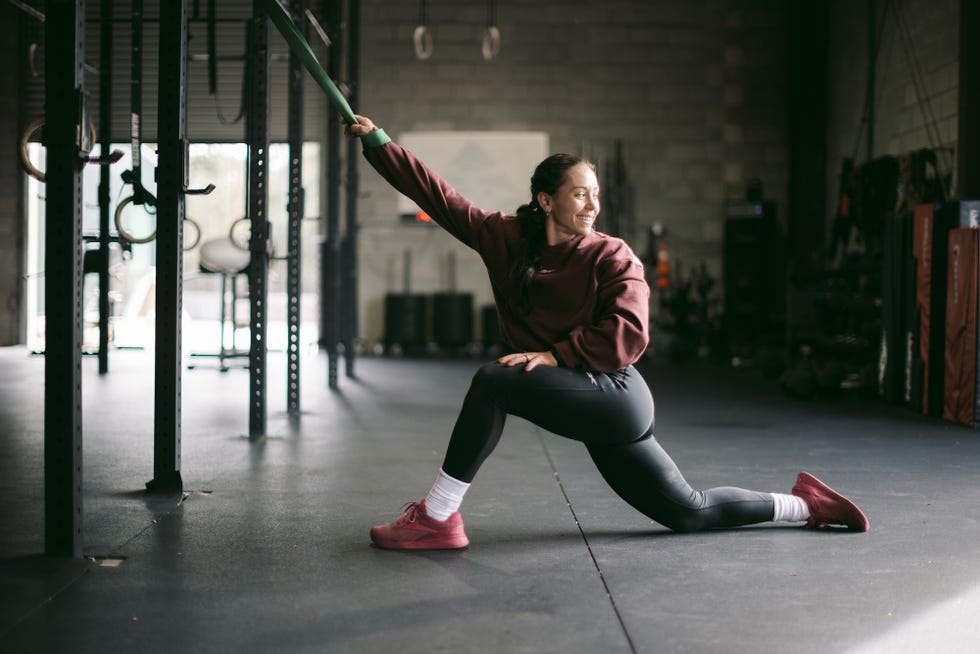 individual performing a stretching exercise in a gym