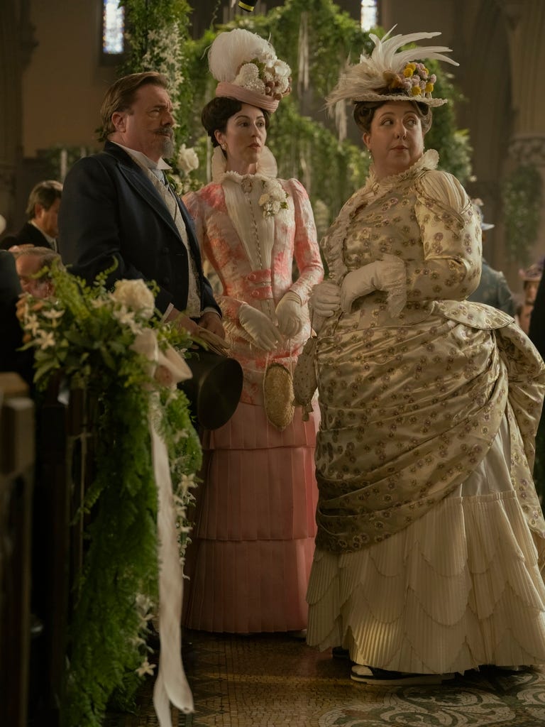 Group of elegantly dressed individuals at a formal event.