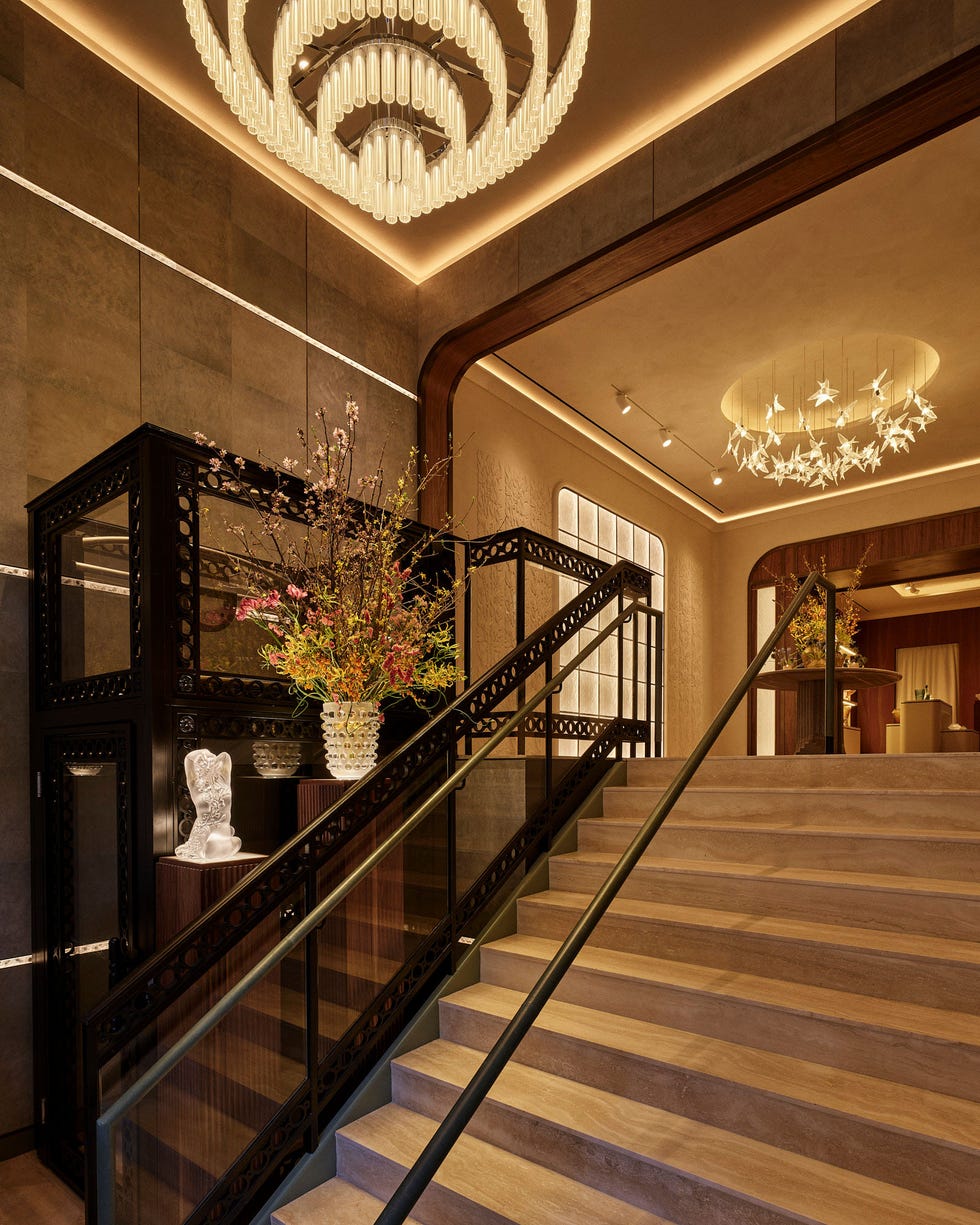 Elegant stairway leading to a light-filled upper level with decorative features.