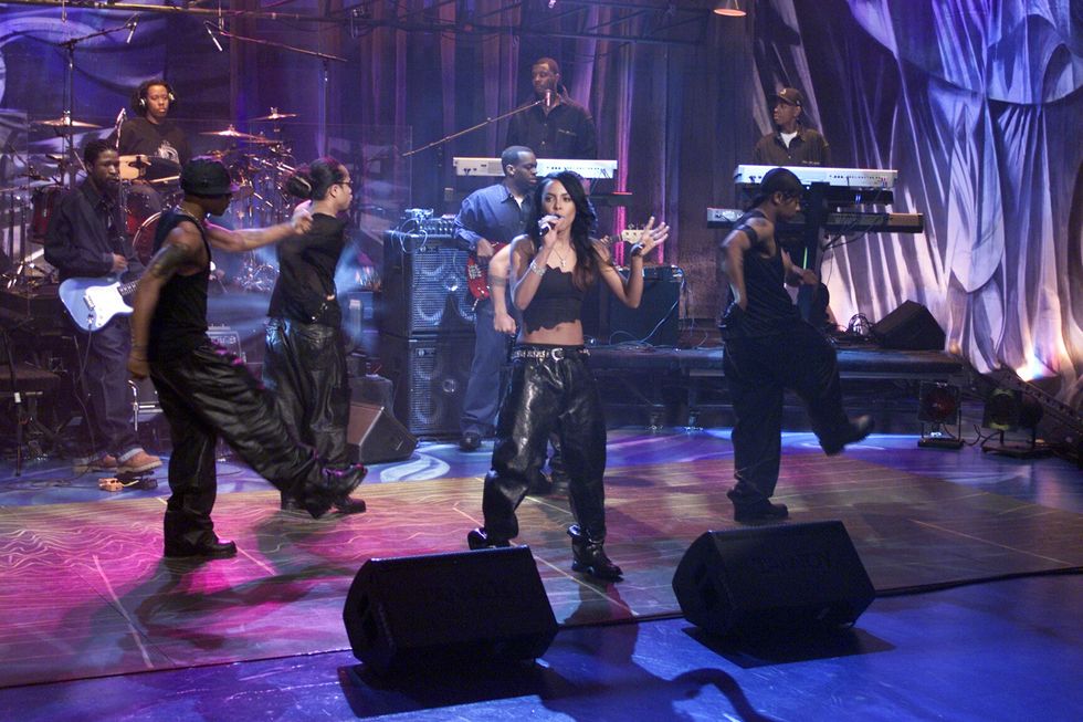 Aaliyah: Aaliyah swoons the audience as her background dancers groove to her music as she performs on The Tonight Show with Jay Leno on April 26, 2000.