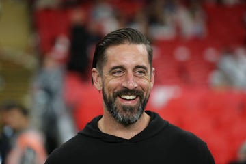 aaron rodgers smiling while looking at something off camera