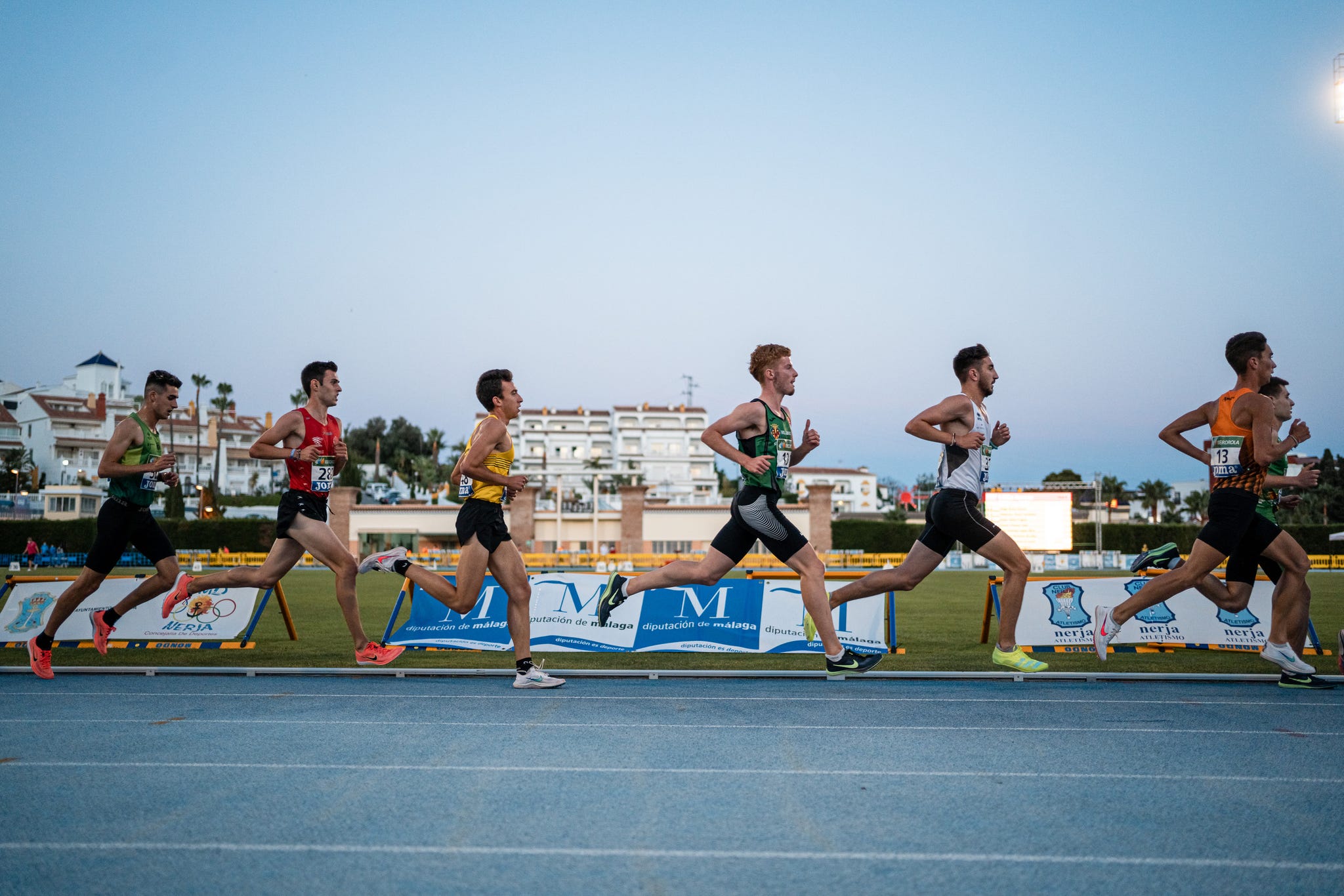 a group of men running on a track